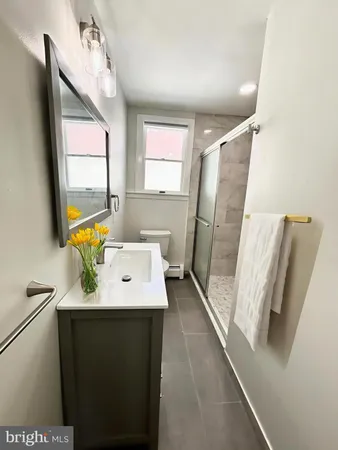 a bathroom with a sink a mirror and vanity