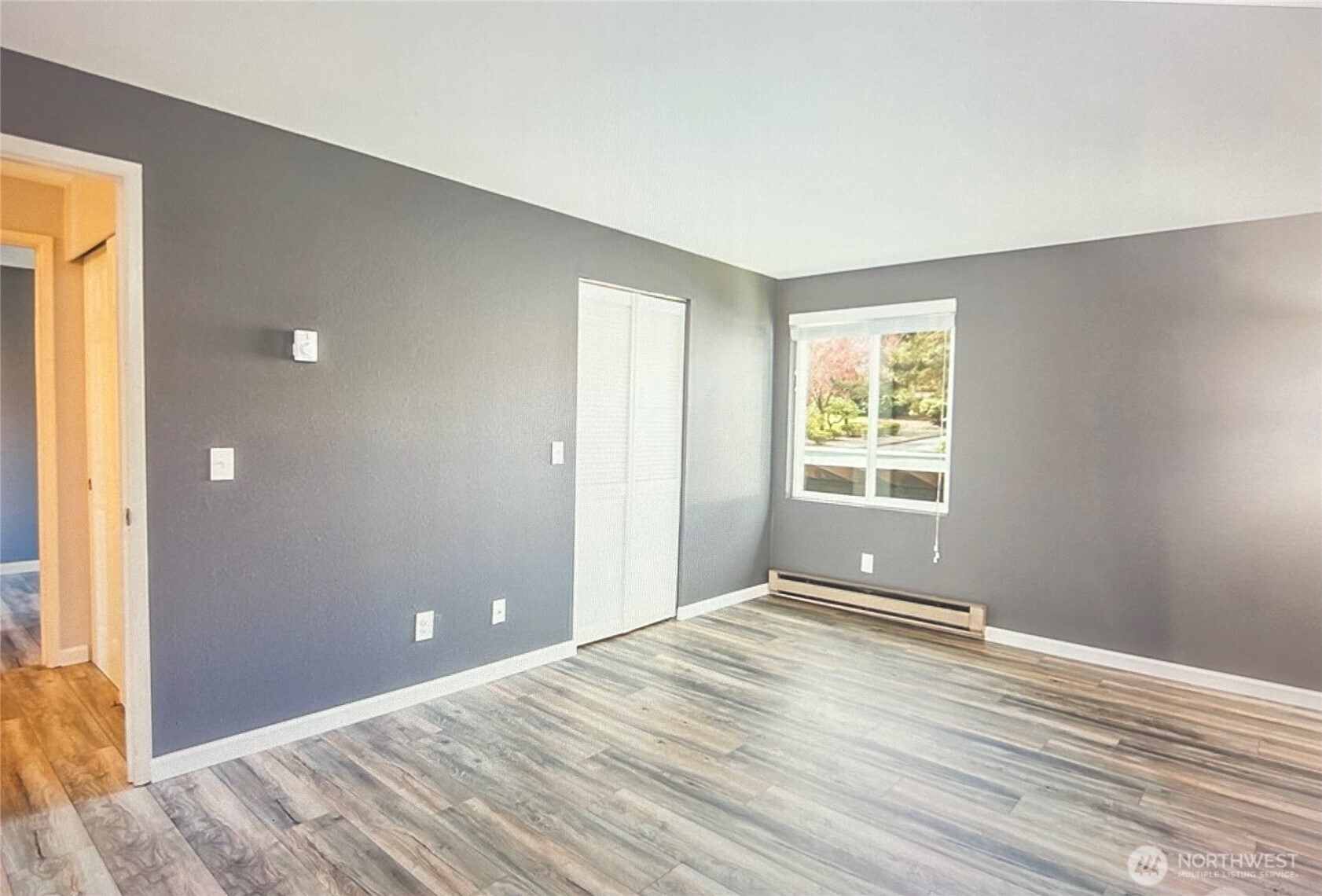 2020 Southwest 318th Place, Unit C3 Federal Way, WA 98023 - Photo 12 of 22 a view of an empty room with wooden floor and a window