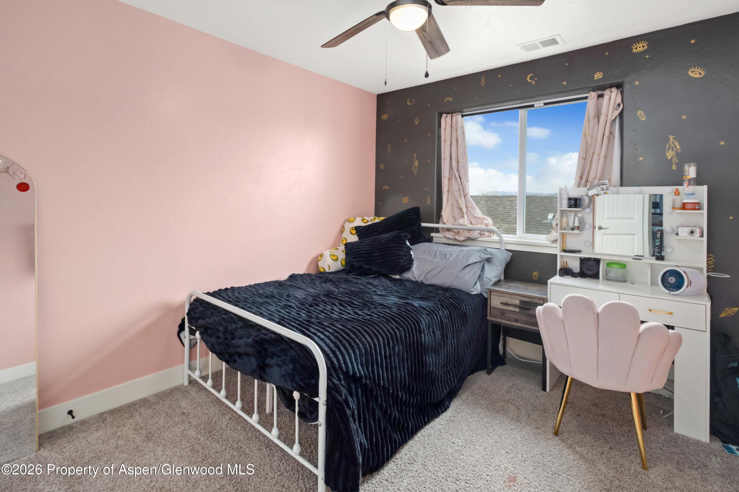 1671 East 17th Circle Rifle, CO 81650 - Photo 16 of 25 a bedroom with a bed a table and chairs