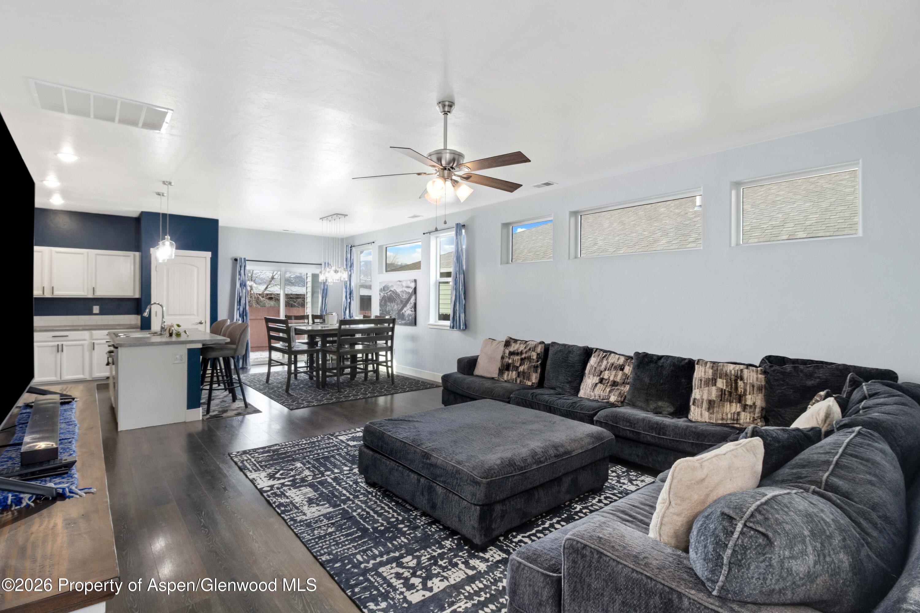 1671 East 17th Circle Rifle, CO 81650 - Photo 5 of 25 a living room with furniture a rug and kitchen view