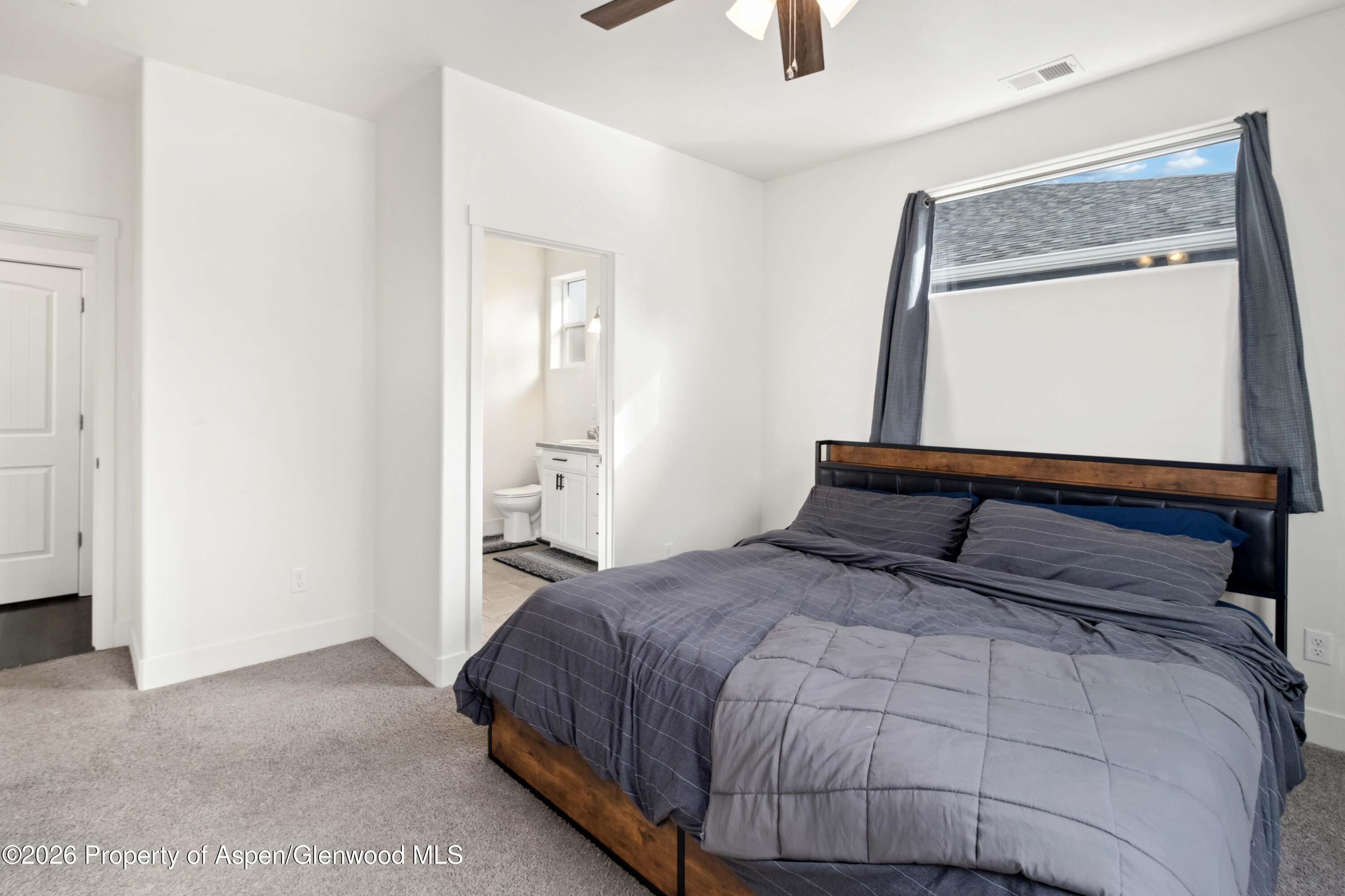 1671 East 17th Circle Rifle, CO 81650 - Photo 9 of 25 a bedroom with a bed and a window