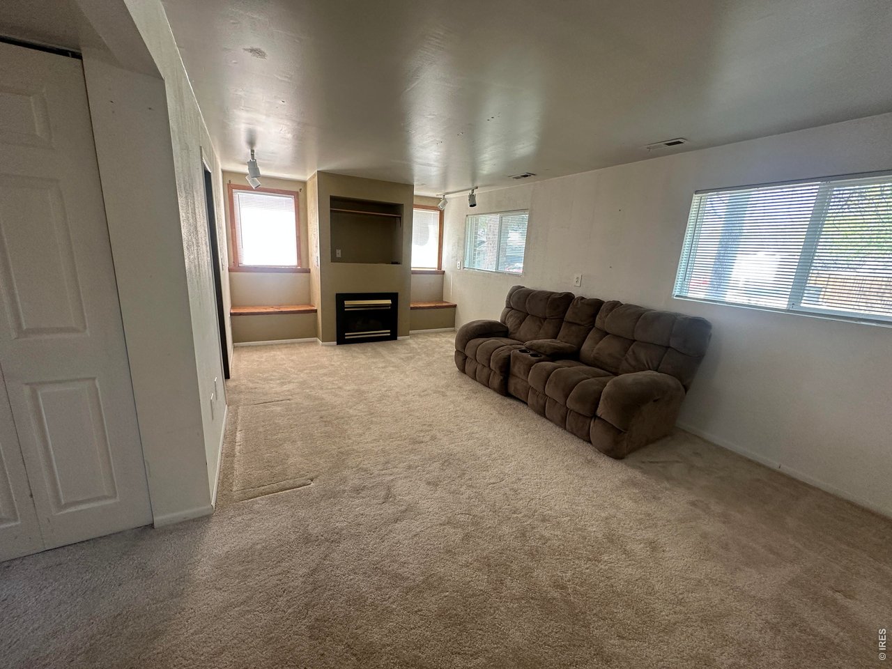 268 Fifth Street Firestone, CO 80520 - Photo 19 of 25 a living room with furniture a flat screen tv and a fireplace