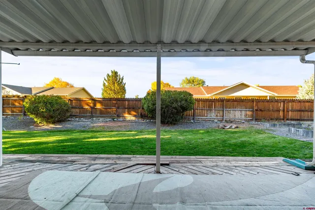 a backyard of a house with a garden and outdoor seating