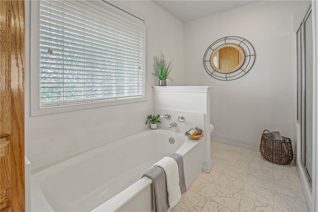1110 County Road 439 Dime Box, TX 77853 - Photo 29 of 50 a bath tub sitting next to a blue sink