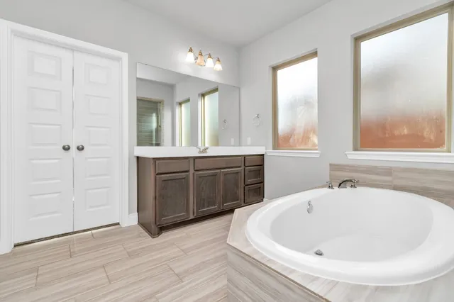 an empty room with closet and natural light