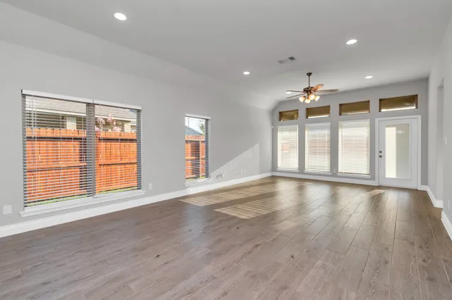 a view of a livingroom with a ceiling fan and wooden floor