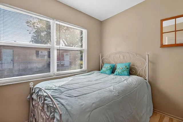 a bed sitting in a bedroom next to a window