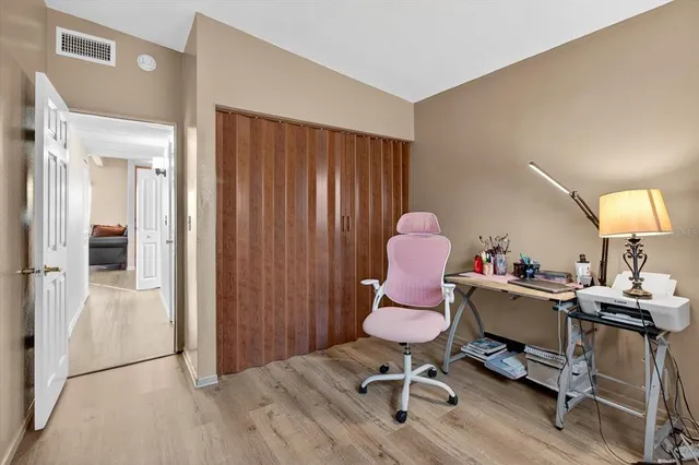a work room with furniture and wooden floor