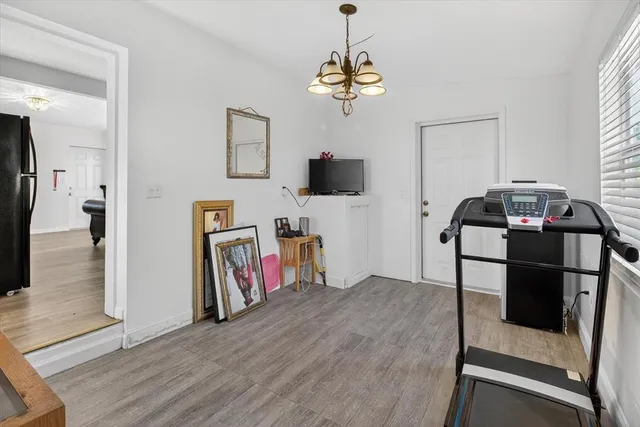 a view of a livingroom with furniture hardwood floor and a window