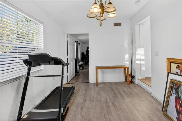 a view of a room with gym equipment and a window