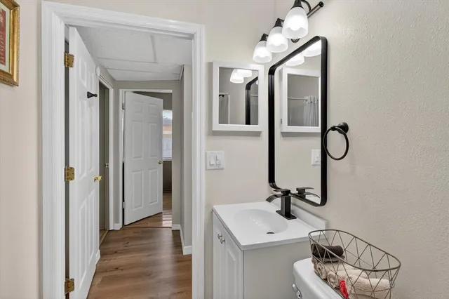 a bathroom with a granite countertop sink and a mirror