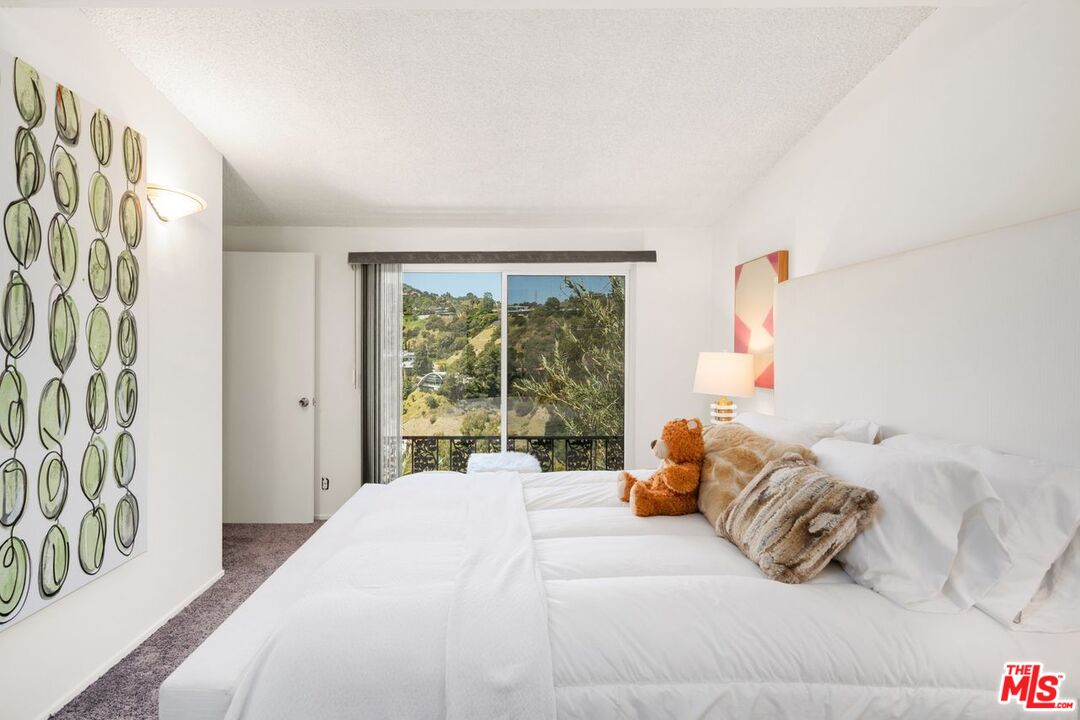 2221 Castilian Drive Los Angeles, CA 90068 - Photo 11 of 15 a bedroom with a bed and a window