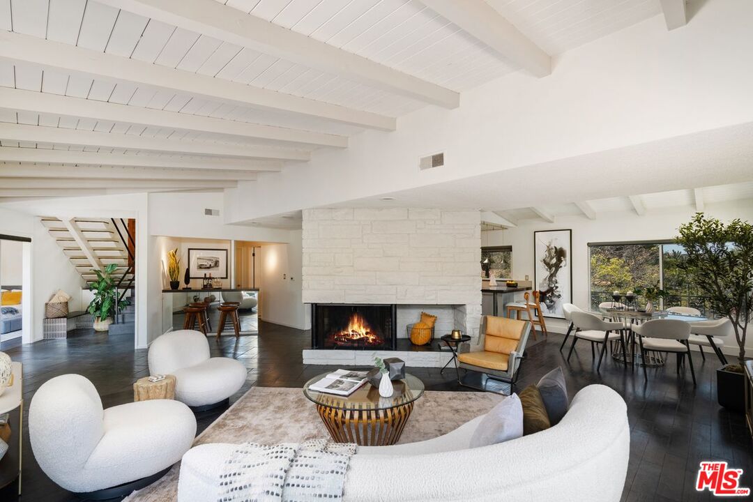 2221 Castilian Drive Los Angeles, CA 90068 - Photo 2 of 15 a living room with furniture a flat screen tv and a fireplace