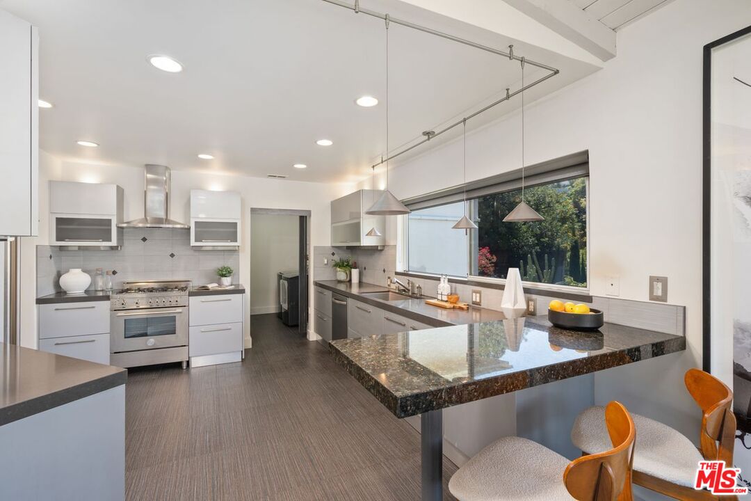 2221 Castilian Drive Los Angeles, CA 90068 - Photo 4 of 15 a kitchen with stainless steel appliances granite countertop a stove and a refrigerator