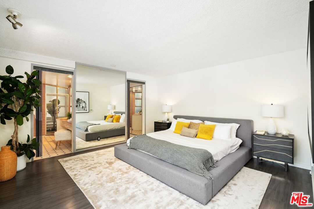 2221 Castilian Drive Los Angeles, CA 90068 - Photo 6 of 15 a bedroom with a bed and wooden floor