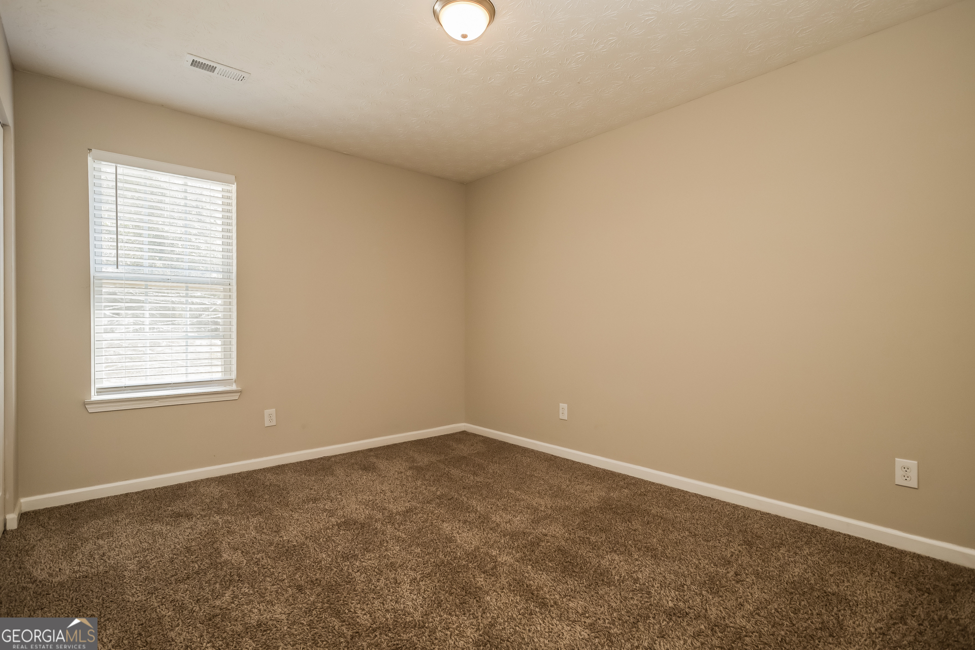 3006 Ryan Road Locust Grove, GA 30248 - Photo 15 of 21 an empty room with a window