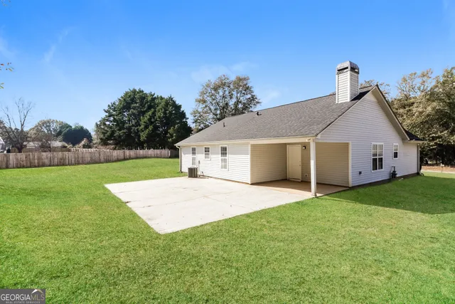 a view of a yard in front of a house with entertaining space