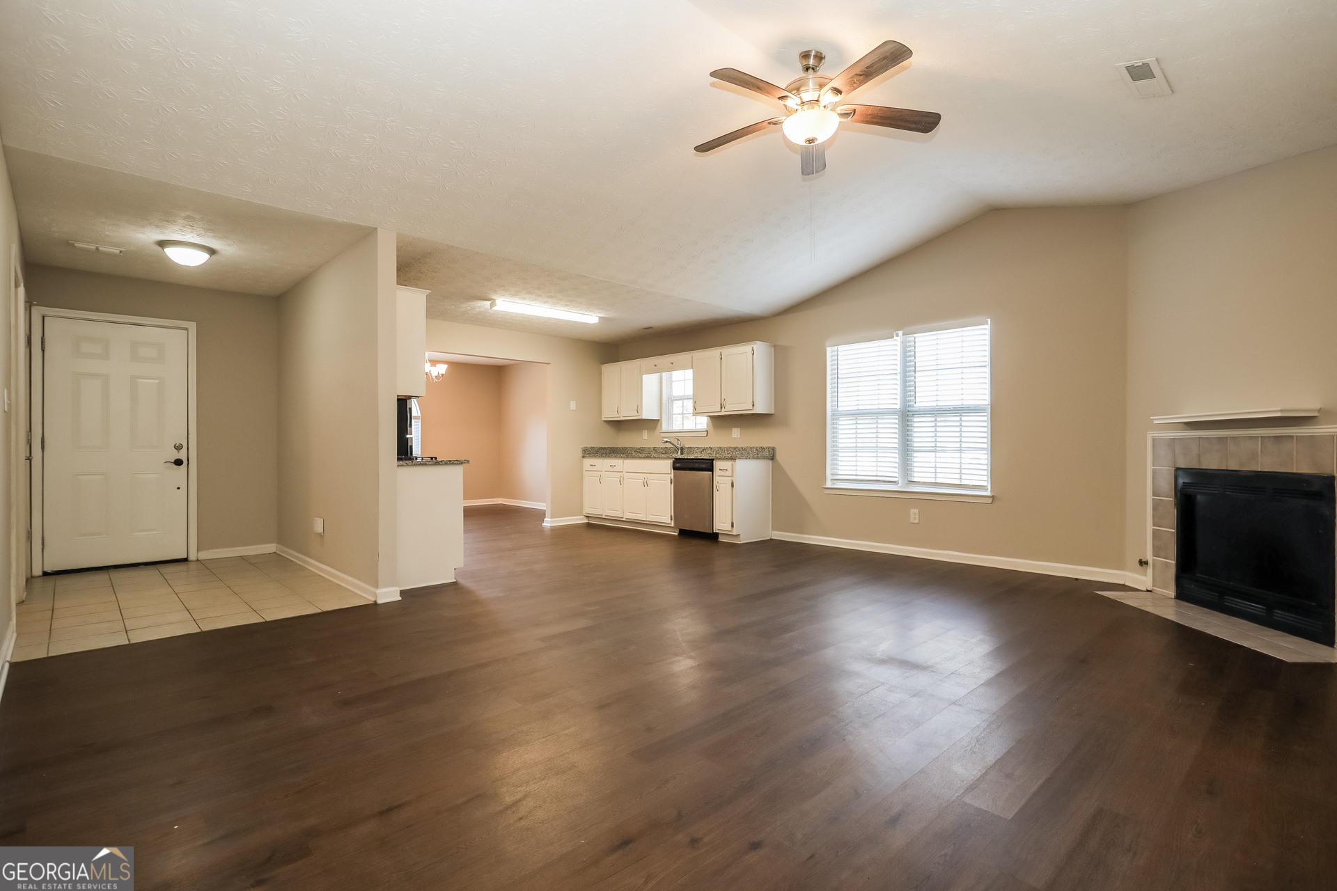 3006 Ryan Road Locust Grove, GA 30248 - Photo 4 of 21 a view of an empty room with window and wooden floor