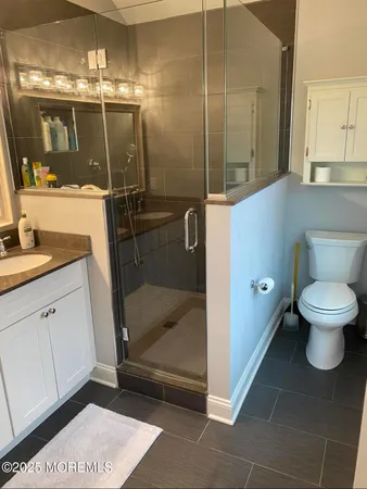 a bathroom with a toilet and a shower