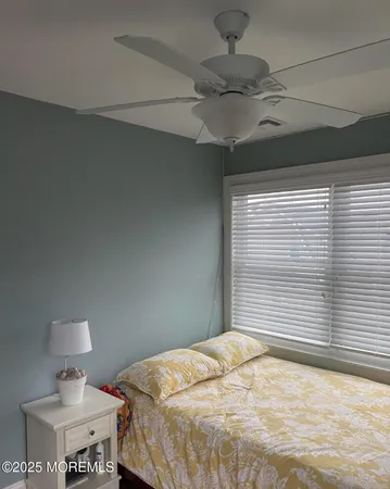 a bedroom with a bed and a night stand