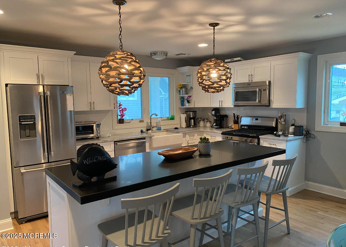 17 Via Ripa Way Sea Bright, NJ 07760 - Photo 3 of 31 a kitchen with a refrigerator a sink and a stove