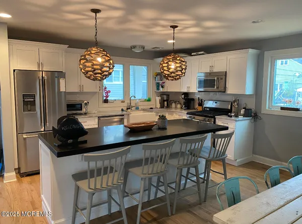 a kitchen with a dining table and chairs