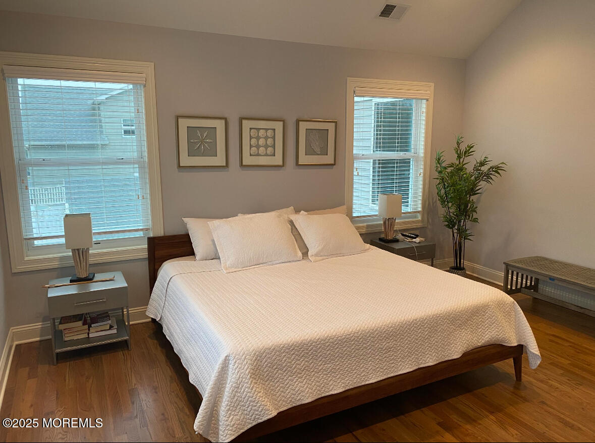 17 Via Ripa Way Sea Bright, NJ 07760 - Photo 9 of 31 a bedroom with a bed and wooden floor