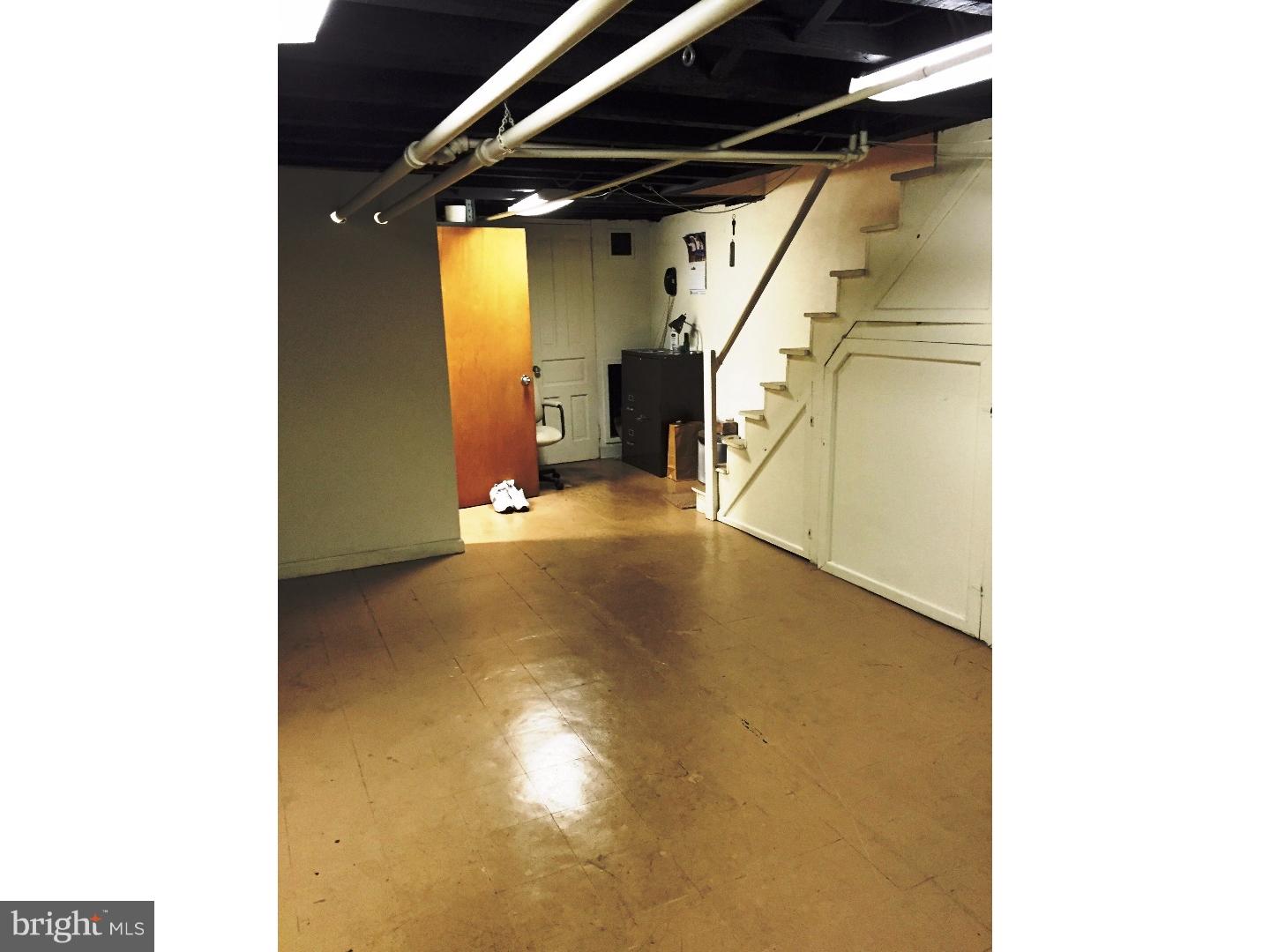 294 Sanford Road Upper Darby, PA 19082 - Photo 16 of 20 a view of a room with stairs and a white wooden door