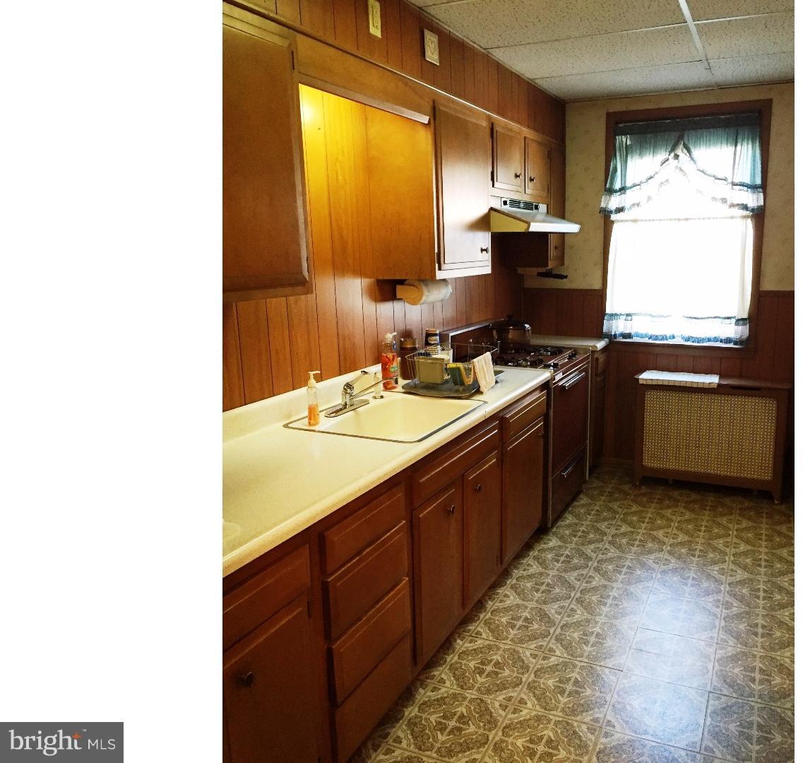 294 Sanford Road Upper Darby, PA 19082 - Photo 5 of 20 a kitchen with a sink stove and refrigerator