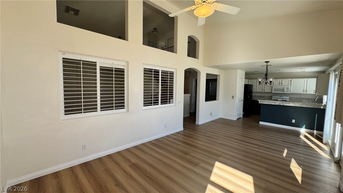 9716 Ridge Creek Place Las Vegas, NV 89134 - Photo 6 of 28 This living area features vaulted ceilings, rich flooring, and a kitchen visible in the background.