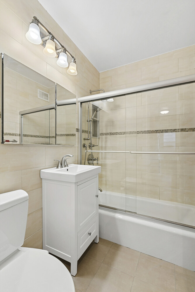 118 East 60th Street, Unit 8CD Manhattan, NY 10022 - Photo 8 of 10 a bathroom with a sink a toilet and shower