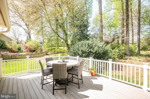 a living room with furniture and a dining table with wooden floor