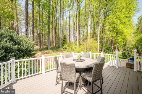 a living room with furniture and a large window with wooden floor