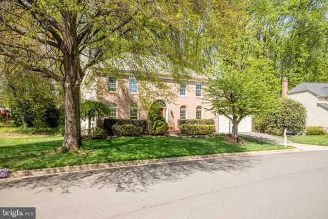 a front view of a house with a yard and a garage