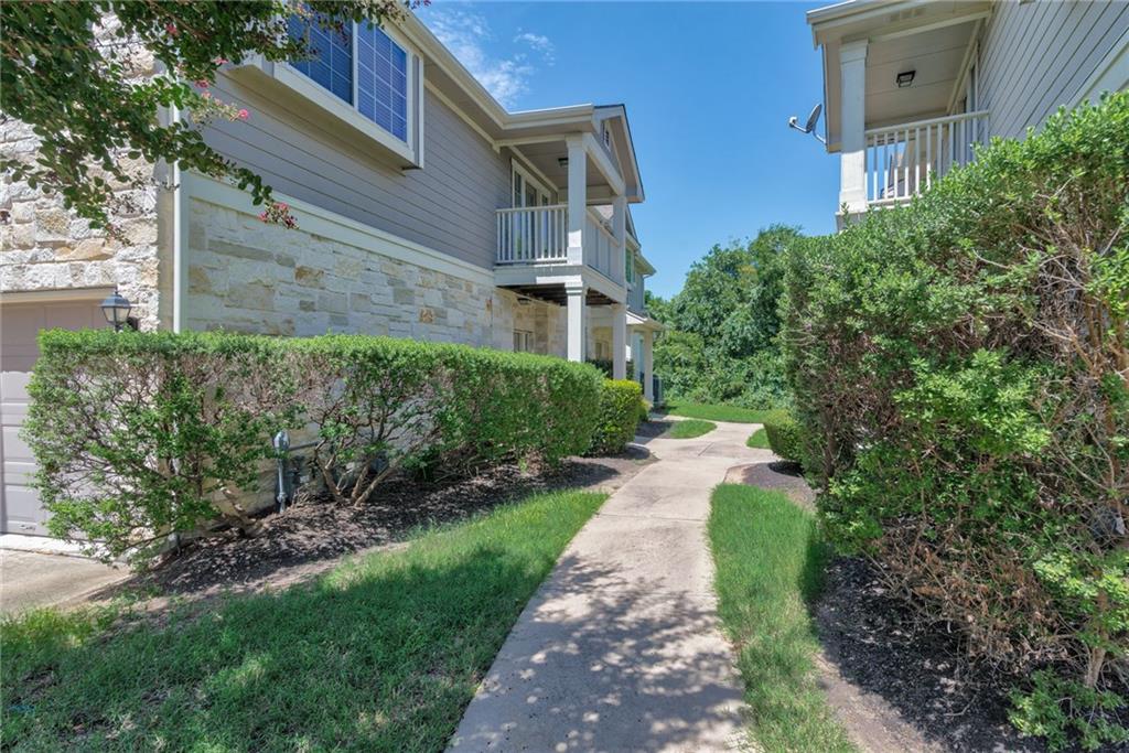 1900 Scofield Ridge Parkway, Unit 5501 Austin, TX 78727 - Photo 11 of 21 Stone and siding facade with a private balcony overlooks a meandering pathway.