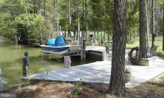 a view of a swimming pool with a patio and a yard