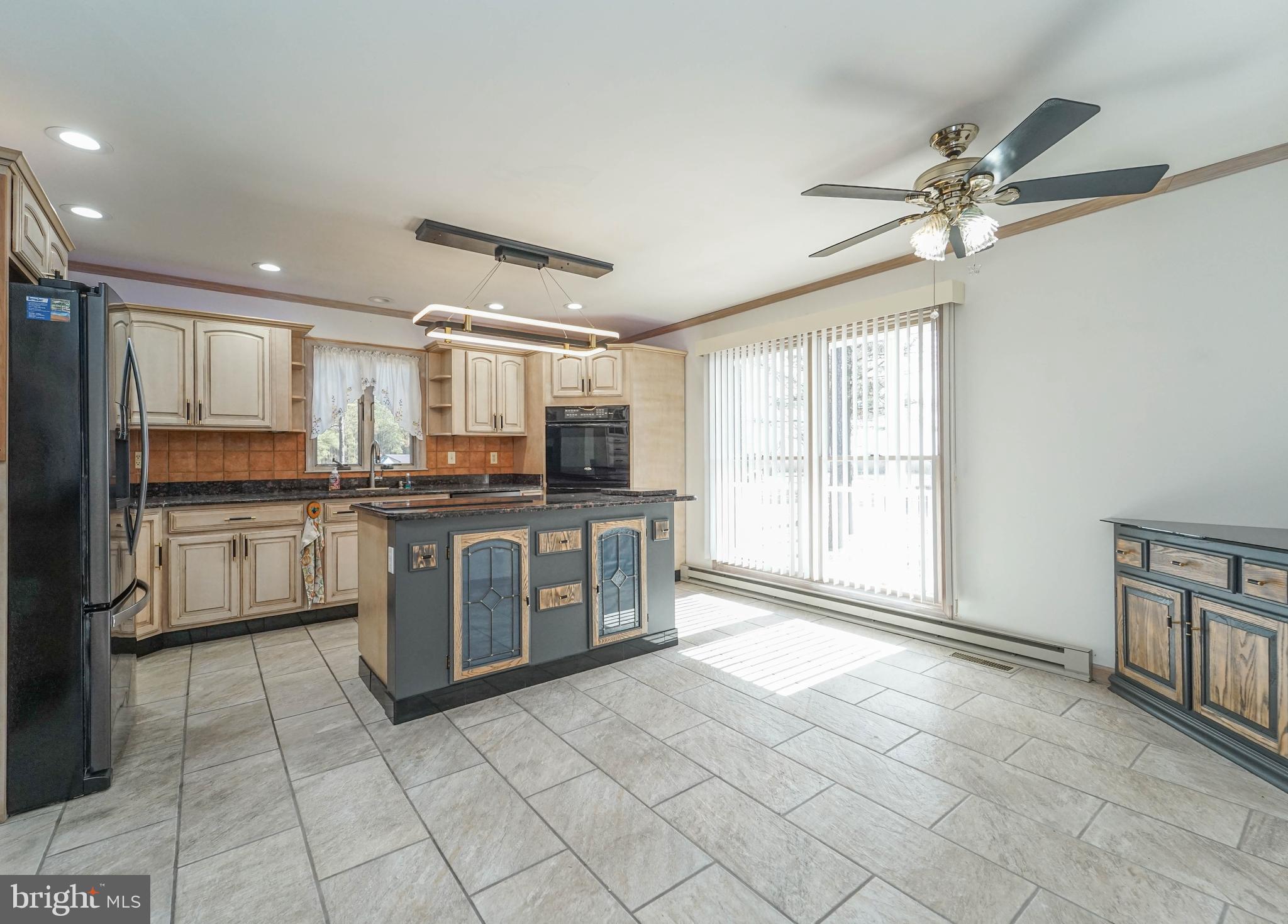 3313 Belfiore Road Church Creek, MD 21622 - Photo 43 of 70 a kitchen with a refrigerator a stove top oven and a sink