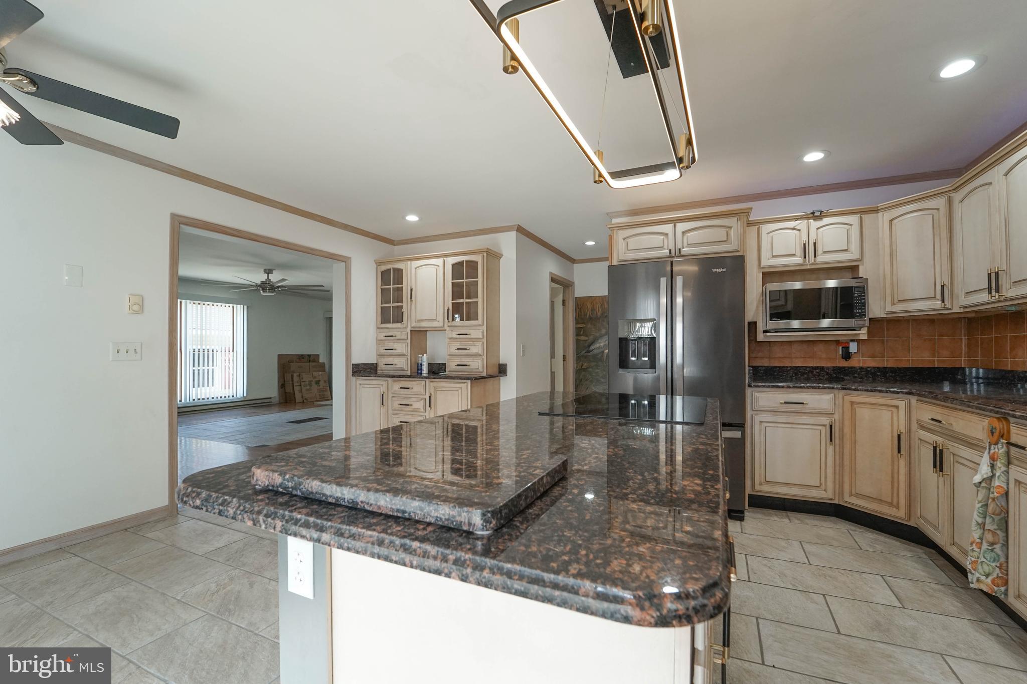 3313 Belfiore Road Church Creek, MD 21622 - Photo 45 of 70 a large kitchen with stainless steel appliances granite countertop a large counter top and a stove top oven