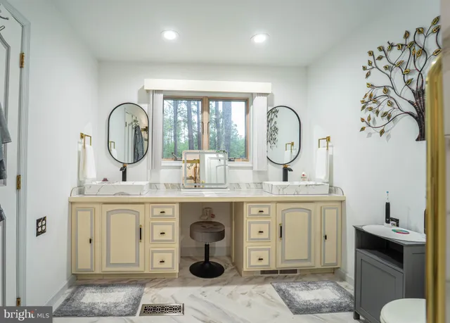 a spacious bedroom with a bed and a chandelier