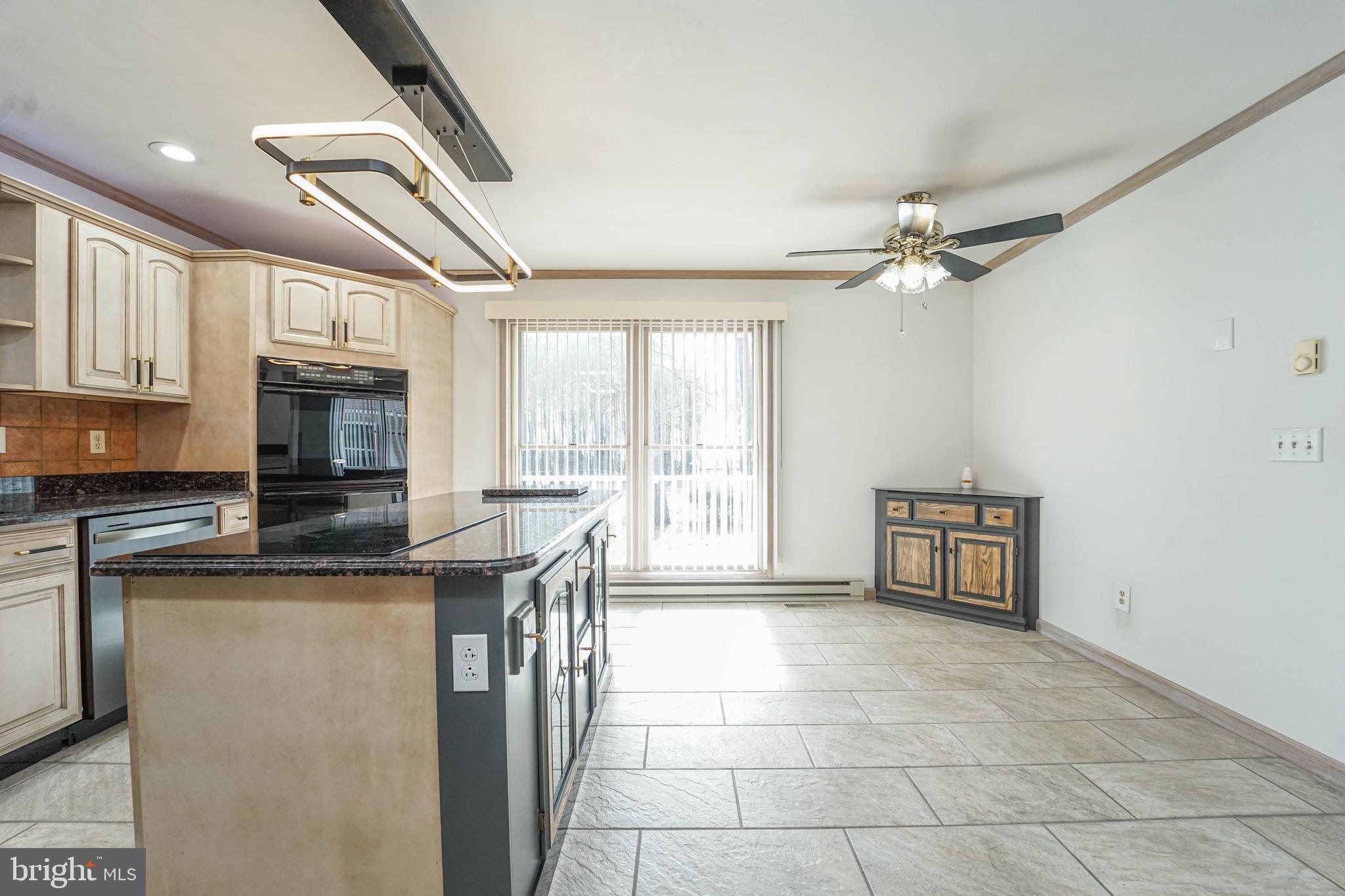 3313 Belfiore Road Church Creek, MD 21622 - Photo 48 of 70 a kitchen with stainless steel appliances granite countertop a stove a sink and a microwave