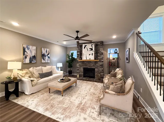 a view of hallway with stairs and wooden floor