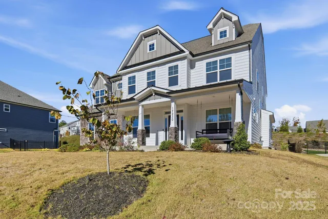 a dining room with furniture potted plants and wooden floor