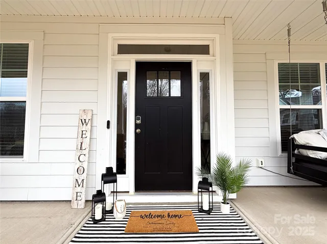 a open kitchen with white cabinets and wooden floor