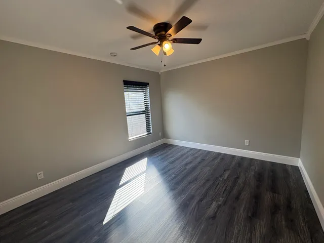 wooden floor in an empty room with a window