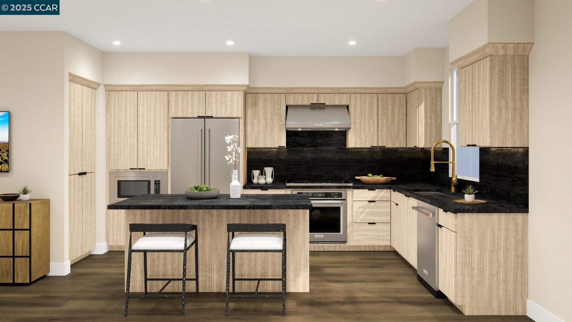 a kitchen with stainless steel appliances a stove a sink a microwave a refrigerator and cabinets