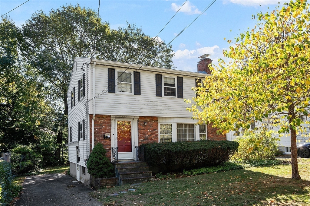 a front view of a house with a garden