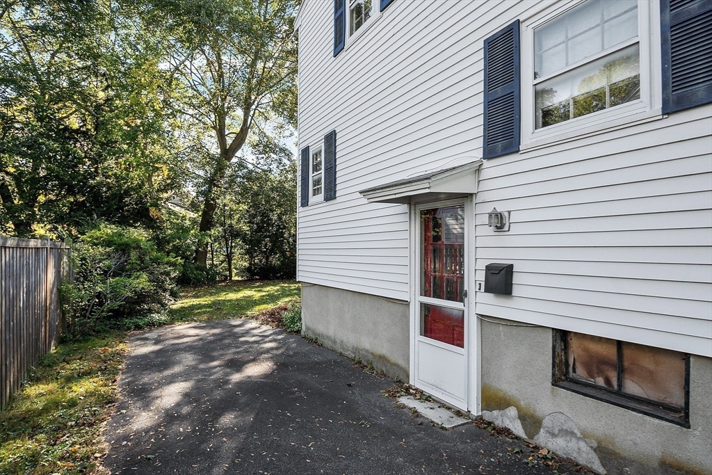 103 North Hancock Street Lexington, MA 02420 - Photo 14 of 18 a view of a small house with a yard