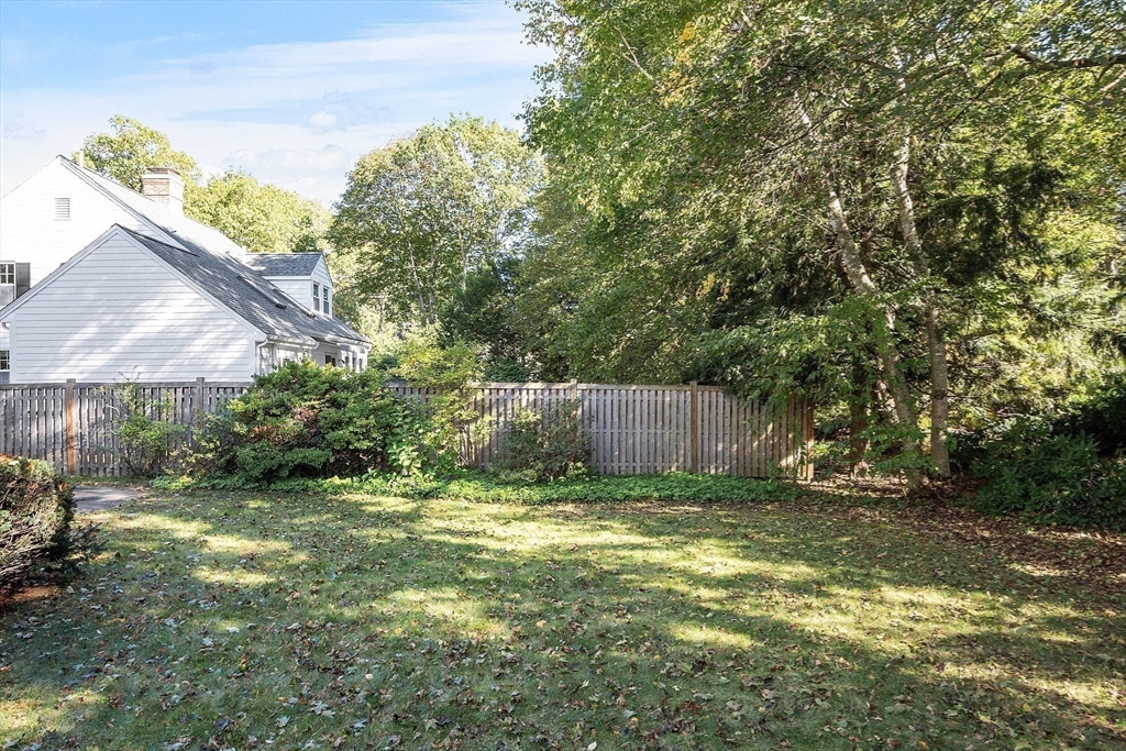 103 North Hancock Street Lexington, MA 02420 - Photo 3 of 18 a view of a yard with a tree