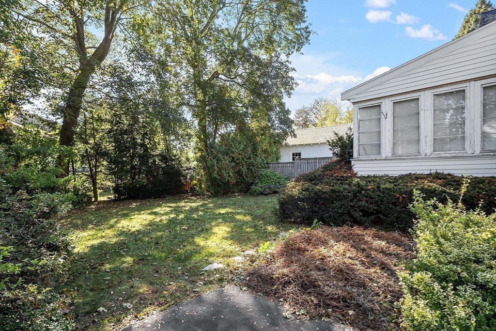 103 North Hancock Street Lexington, MA 02420 - Photo 7 of 18 a view of a house with a yard and plants