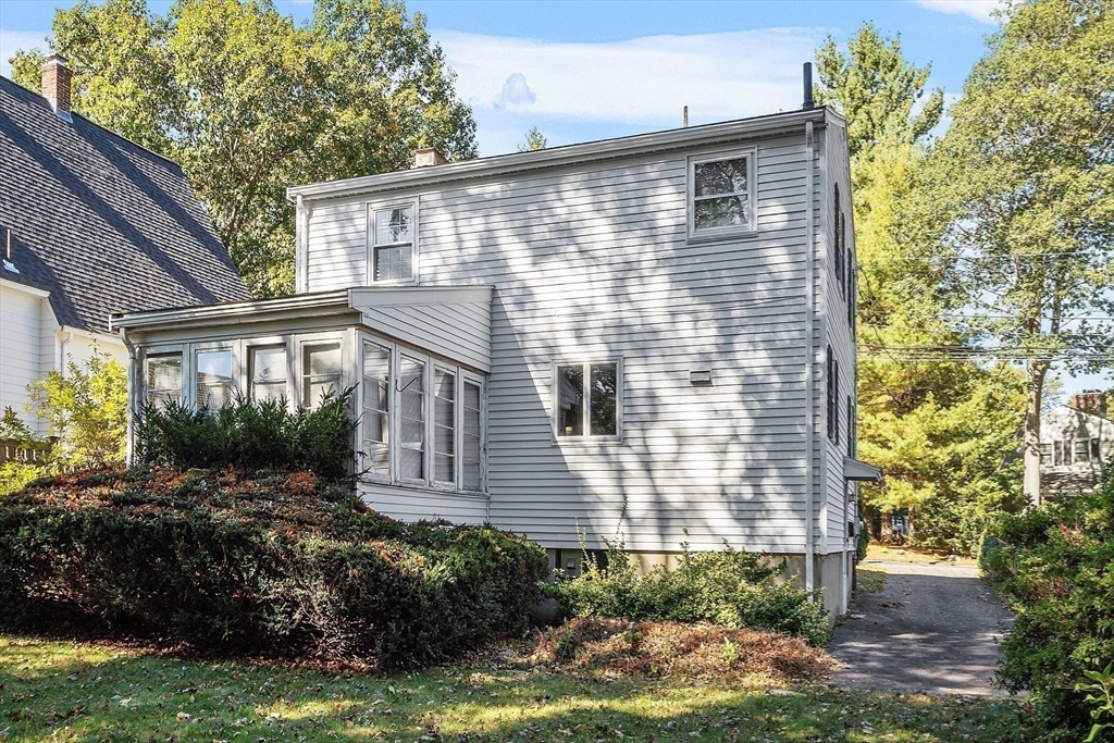103 North Hancock Street Lexington, MA 02420 - Photo 8 of 18 a front view of a house with a yard